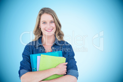 Composite image of smiling student holding notebook and file