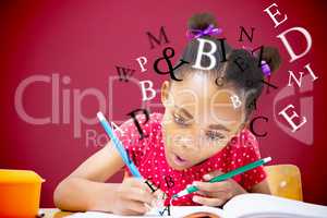 Composite image of cute pupil writing at desk in classroom