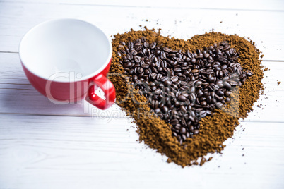 Coffee on a table in heart shape with cup