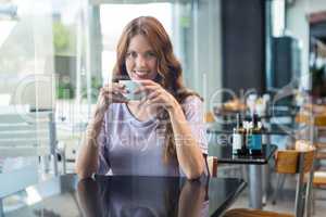 Pretty brunette enjoying a coffee