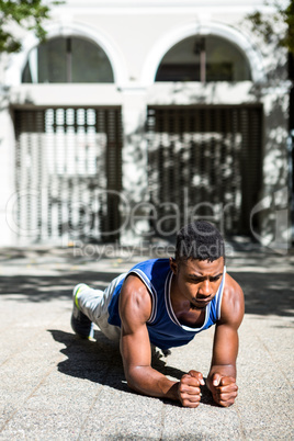 A muscular man on plank position