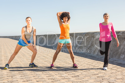 Sporty women stretching together