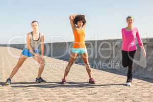 Sporty women stretching together