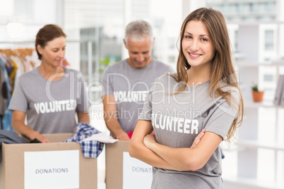 Smiling female volunteer with arms crossed