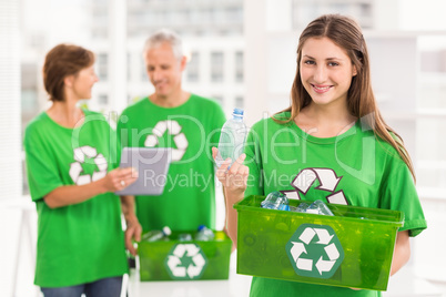 Smiling eco-minded woman holding recycling box