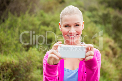 Smiling female hiker taking a selfie