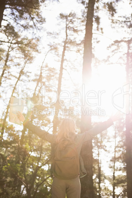 Carefree blonde hiker with arms outstretched