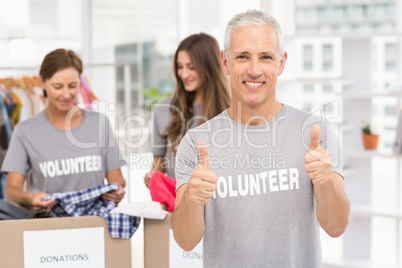 Smiling volunteer doing thumbs up