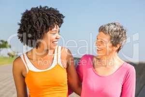 Two sporty women smiling at each other