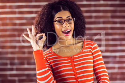 Attractive young woman showing OK sign