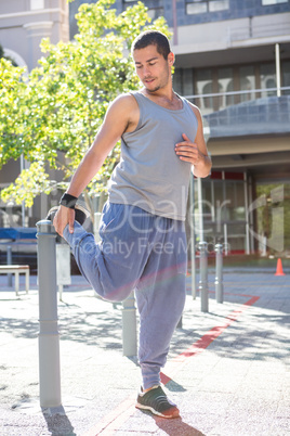 An handsome athlete stretching