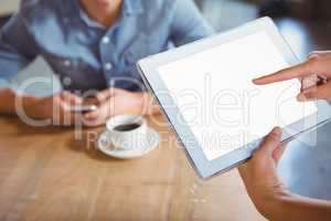Smiling waitress using tablet pc