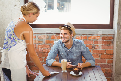 Handsome hipster smiling at blonde waitress