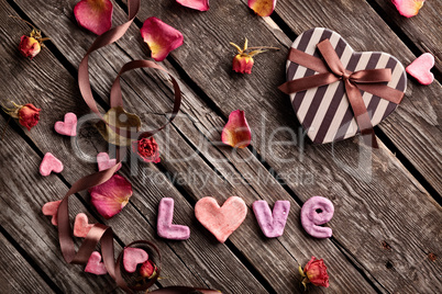 Word Love with heart shaped gift box