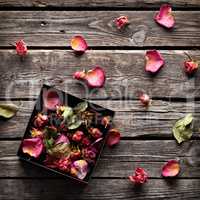 Rose petals inside open gift box