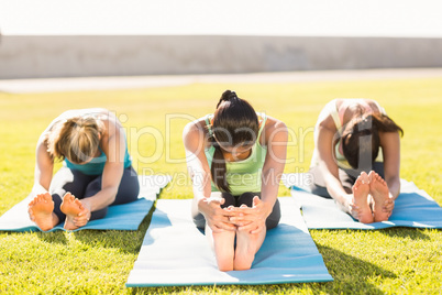 Sporty women stretching on exercise mat