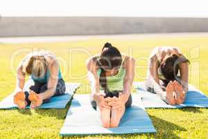 Sporty women stretching on exercise mat