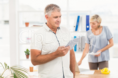 Thoughtful businesswoman holding a tablet