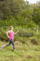 Pretty blonde athlete jogging