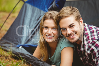 Portrait of a young happy couple lying in a tent Portrait of a young happy couple lying in a tent