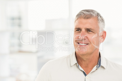 Smiling businessman looking away in the office