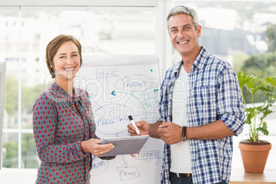 Smiling casual business colleagues with tablet