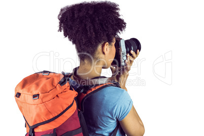 Young woman with backpack taking picture