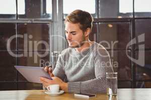 Handsome man touching on tablet computer