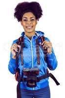 Portrait of a young woman with camera and backpack