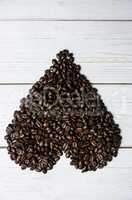 Coffee beans on a table in heart shape