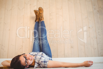 Pretty hipster with legs on wall