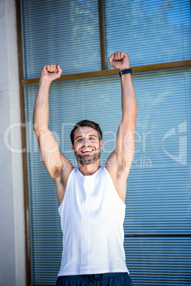 Handsome athlete gesturing victory