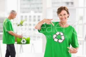 Smiling eco-minded woman showing her recycling shirt