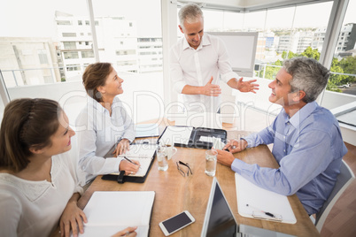 Business people listening to colleagues presentation