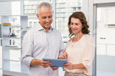 Casual business colleagues working with tablet