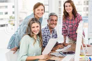 Four casual colleagues using computer