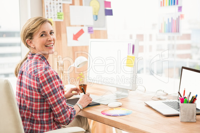 Smiling casual designer working with digitizer