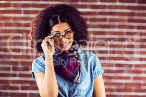Smiling attractive hipster posing with glasses