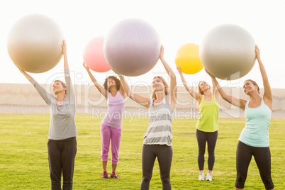 Smiling sporty women working out with exercise balls