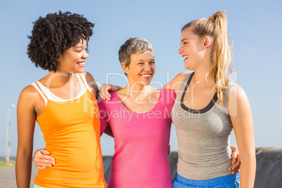 Sporty women smiling at each other