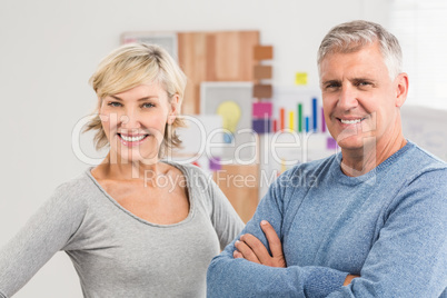 Smiling business colleagues with arms crossed