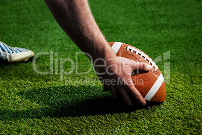 American football player preparing for a drop kick