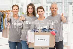 Smiling volunteers with donation box
