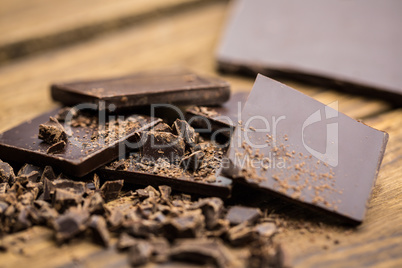 Pieces of chocolate on a wooden table