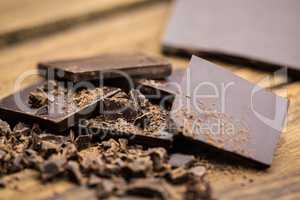 Pieces of chocolate on a wooden table