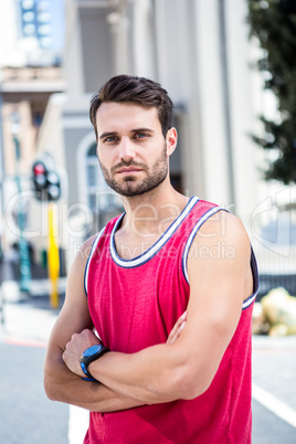 Concentrated athlete with arms folded