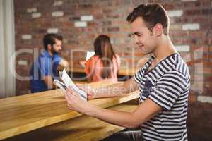 Young man reading a newspaper