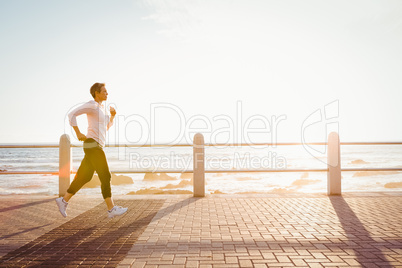 Sporty woman jogging at promenade