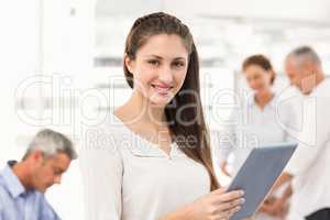 Smiling businesswoman with tablet in a meeting