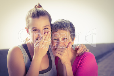 Sporty mother and daughter laughing
